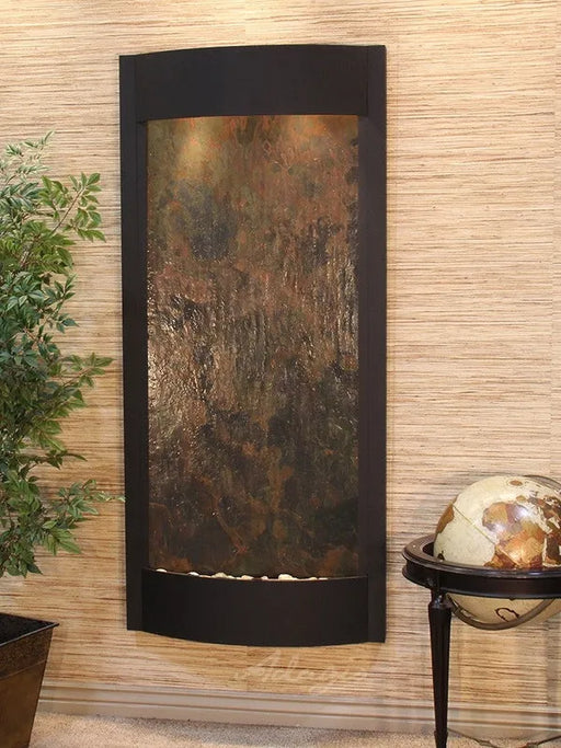 Decorative wall fountain by adagio water features with textured panel on a beige wall