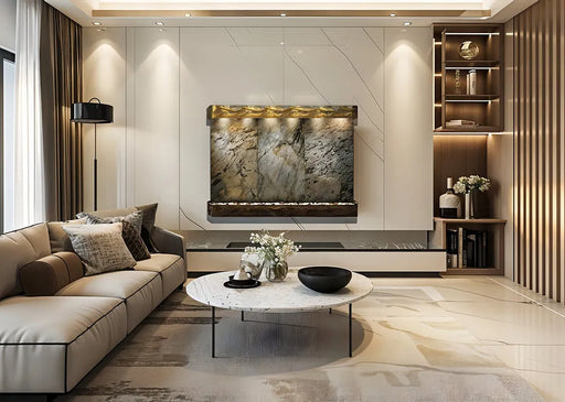 A modern living room featuring an Adagio water feature with a natural stone face and illuminated bronze or copper accents mounted on a large marble wall.