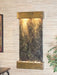 Decorative in door wall fountain by adagio water features with marble-like design and brass accents on a light wood paneled wall.