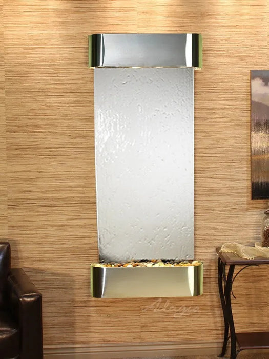 adagio Wall-mounted water feature with metallic finish on a wooden wall.
