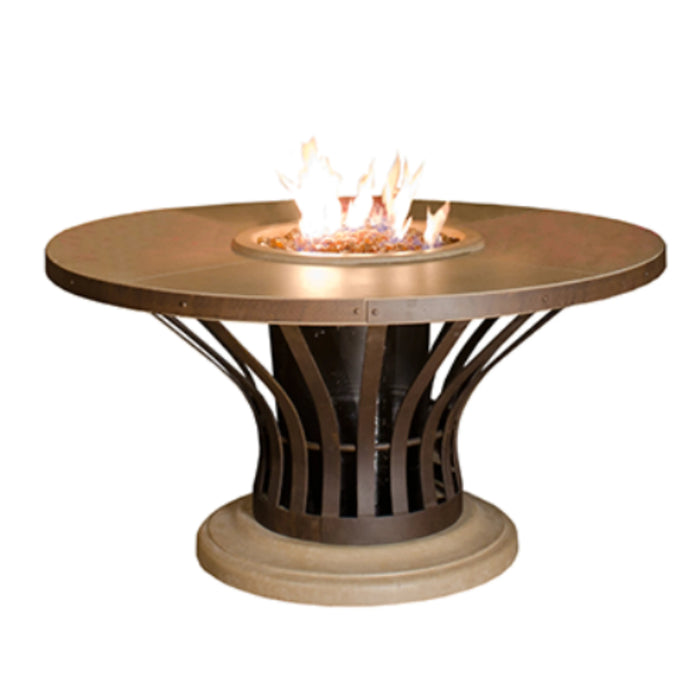 A photo of the American Fyre Designs Fiesta Round Dining Fire Table, showcasing its round shape, bronze metal base, and a warm, inviting fire burning in the center.