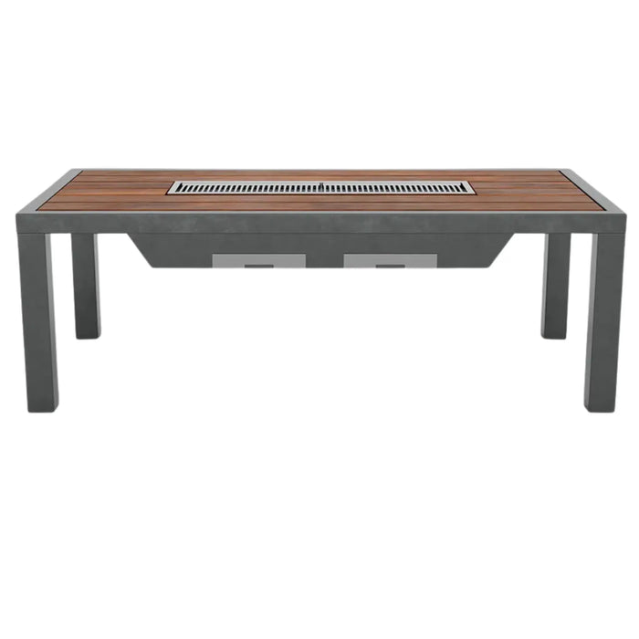 A rectangular outdoor dining table with a wood-slat top and a central built-in grill, supported by dark grey metal legs.