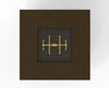 A gold-colored gas burner inside a bronze square frame. warming trends. 103816BRZ