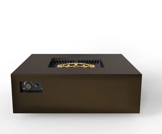 A front view of a square gas fire pit table with a bronze finish. A gold-colored burner is visible in the center, with flames flickering above it. Controls are located on the side.