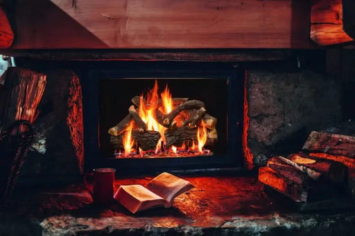 arizona wethered oak charred grand canyon gas logs burning in indoor fire place in a basement. basement is lit with orange and yellow flames by the fire pit