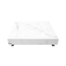 A low, square coffee table with a white marble top and base, resting on small, dark, round feet.