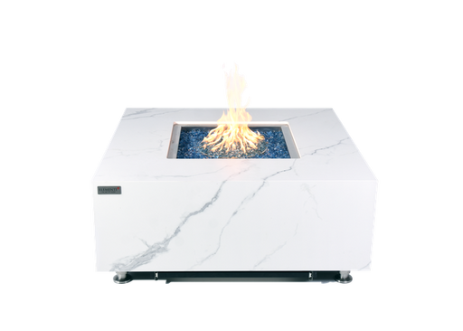 yellow and orange fire lit by fire table on natural or propane gas. the fire table is white marble with black accents. It has blue fibre glass in the middle of fire table with flat marble surface around it