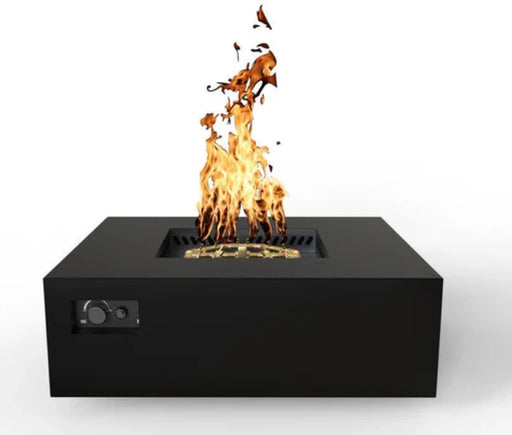 A front view of a square gas fire pit table with a black finish. Flames are dancing above the gold-colored burner. Controls are located on the side.