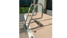Metal boarding boat ladder on a boat with a glass door in the background