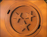 A close-up of a round, rust-colored fire pit lid with three stars in the center. The stars are arranged in a triangular pattern.