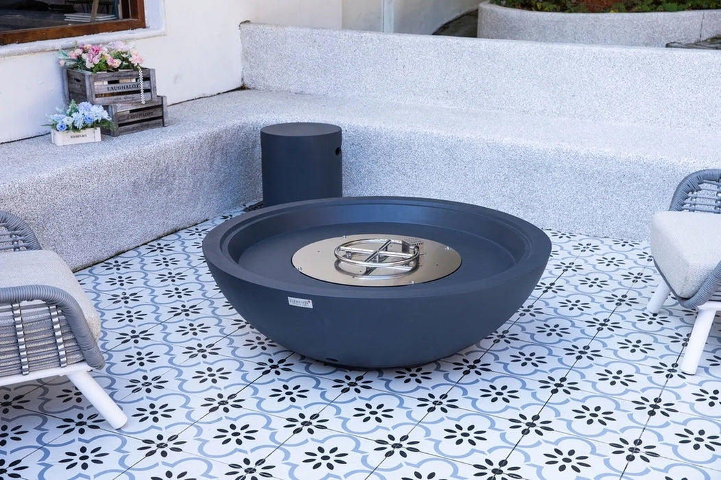 dark gray fire pit table on a patterned patio with chairs and decorative elements.