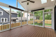 Comfortable screened-in porch equipped with a ceiling fan and two electric patio heaters for year-round enjoyment.