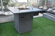 elementi alps bar height fire pit table OFG222 light grey with windscreen on grass patio