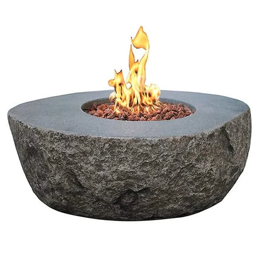 elementi boulder rock fire pit table ofg110 with flame on white background. fire pit is lit on red lava rocks