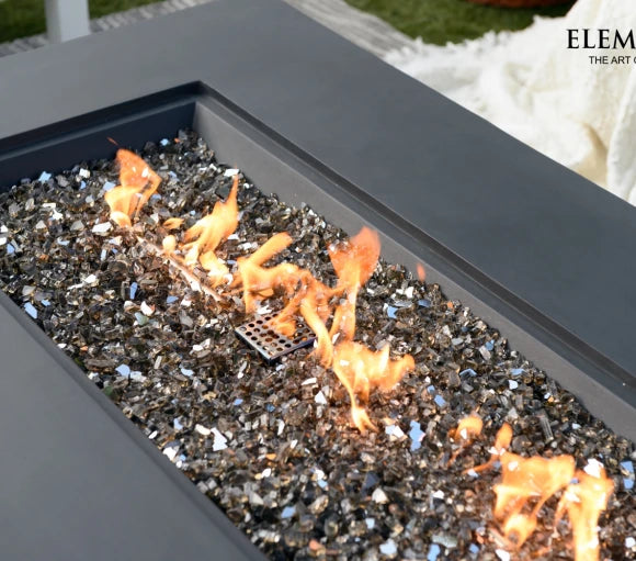 fire pit table rectangle buring on brown fire glass close up