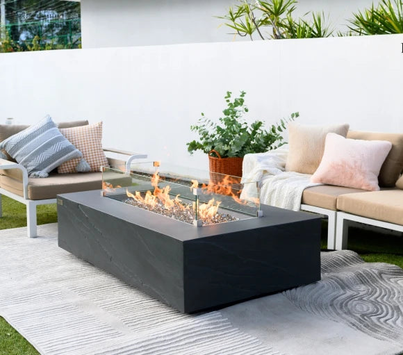 rectangle fire pit tables. fire pit is lit with yellow and orange flame