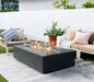 rectangle fire pit tables. fire pit is lit with yellow and orange flame