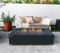 rectangle fire pit table dark grey with windshield. fire pit table is lit with brown fire glass