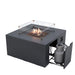 Fire pit table with flames, glass wind guard, open door revealing a gray propane tank on a sliding mechanism.