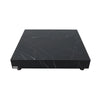 A square coffee table with a black marble top featuring white veining, and a black base.