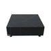 A low, square coffee table made of black marble porcelain with subtle white veining. It rests on small, dark, round feet.