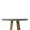 Close-up of a round grey outdoor dining table with a wooden base.