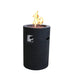 black concrete fire column with lava rocks in pit. fire pit is lit with yellow and orange flame on a white background