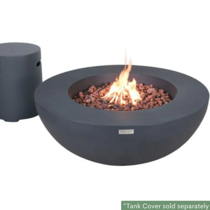 dark grey round fire pit table with fire pit lid in the middle on brown lava rocks. Fire pit table is attached to round tank cover