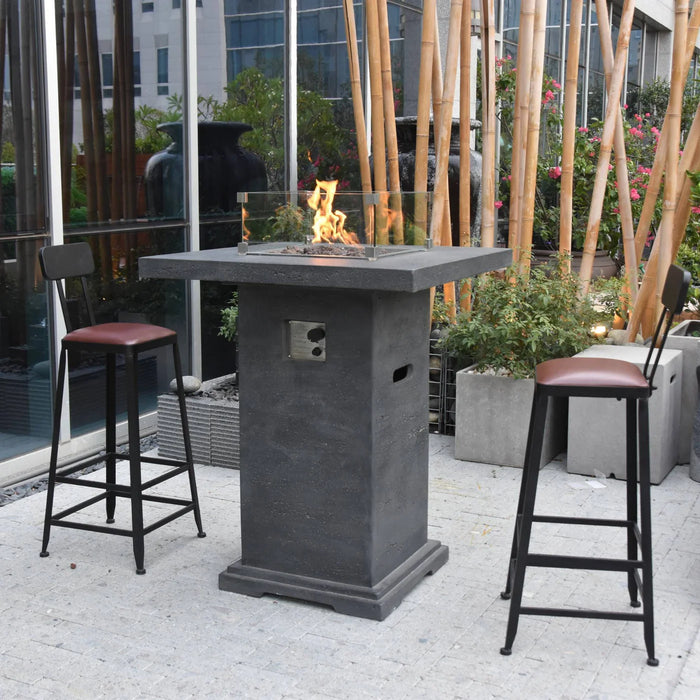 dark grey bar height fire pit table is lit on lava rocks and is blowing yellow and orange flames outside USA bar