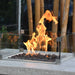 bar height patio table set with fire pit and fire burning in the middle on lava rocks with square windscreen around it