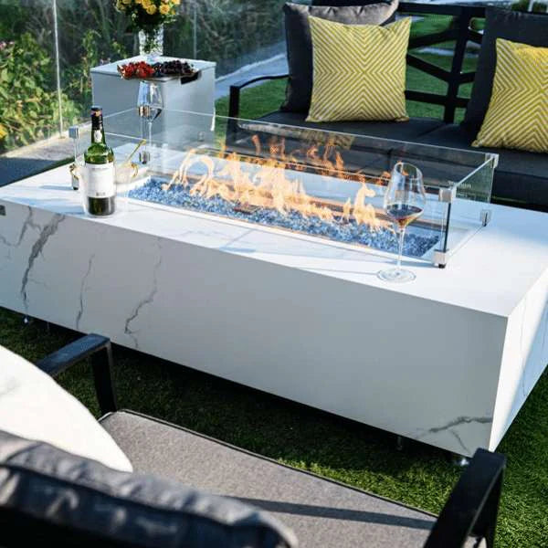 white rectangle fire pit table with glass guard with wine bottle on fire table