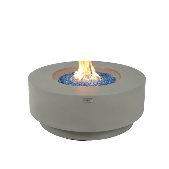 elementi plus Colosseo round propane fire pit table burning on blue fire glass on a white background