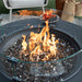 elementi plus round gas fire pit table with round windscreen protecting fire pit flames burning on fire glass