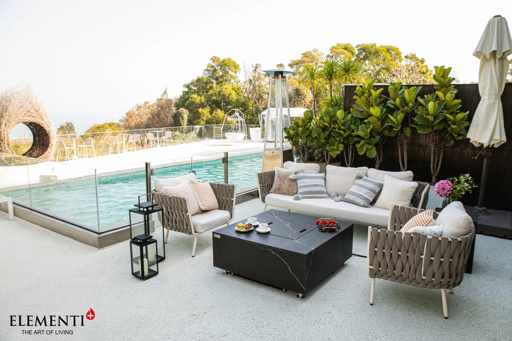 bulgaria black square fire pit table is beside swimming pool on outdoor patio