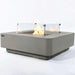 square fire pit table with glass windscreen around burning fire pit on a white background