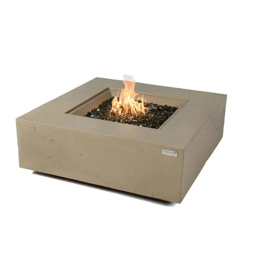 sandstone square fire pit table with fire pit lit and burning on fire glass on a white background