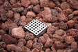 Metallic grid embedded in red-brown decorative stones