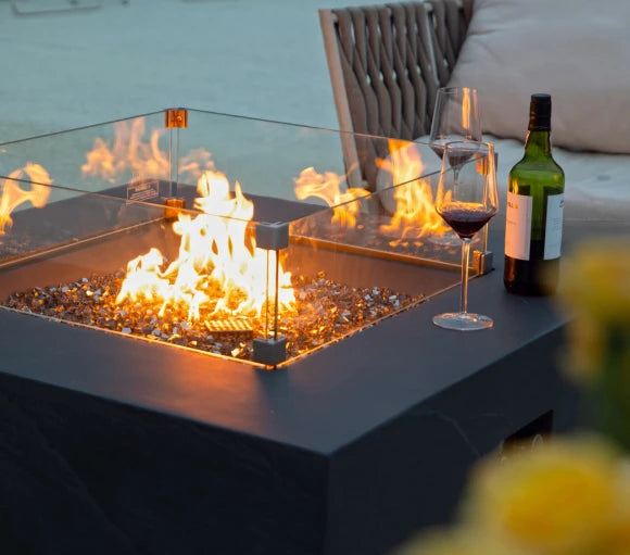 square fire pit table lit on fire glass with glass wind screen cover