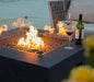 square fire pit table lit on fire glass with glass wind screen cover