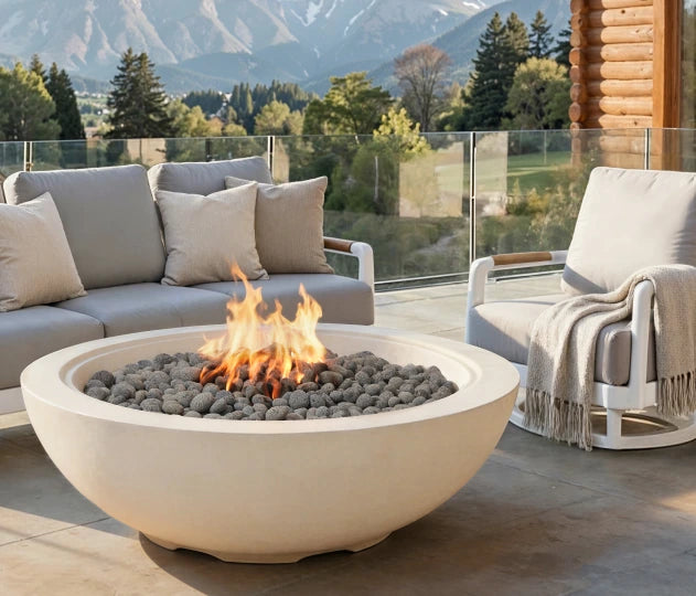 Outdoor patio with fire pit, sofa, and chair in a mountainous landscape