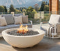 Outdoor patio with fire pit, sofa, and chair in a mountainous landscape