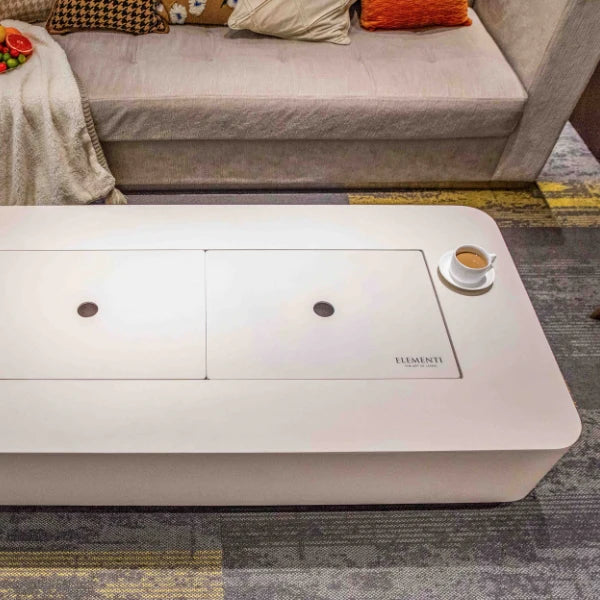 creamy white rectangular fire table with lid and coffee cup on table top view