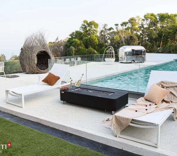 black fire pit coffee table in outdoor patio beside pool