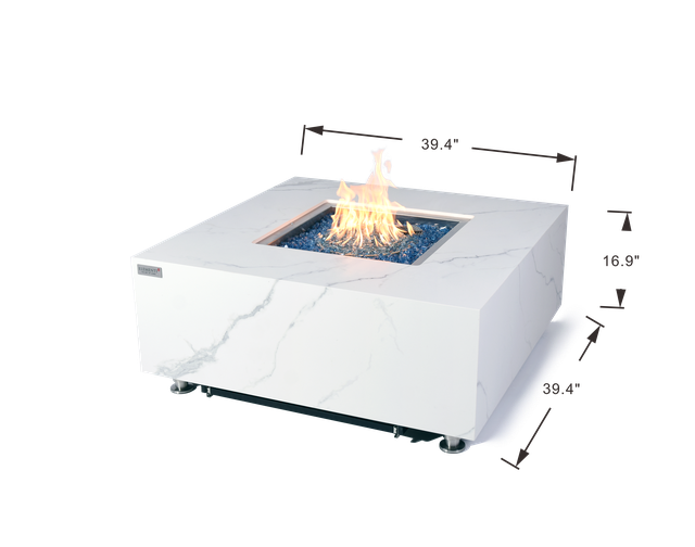 white marble fire table with blue fiber glass in the middle. the fire pit table is lit with yellow and orange fire