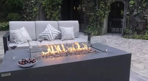 fire is lit on lava rocks in the middle of a fire table