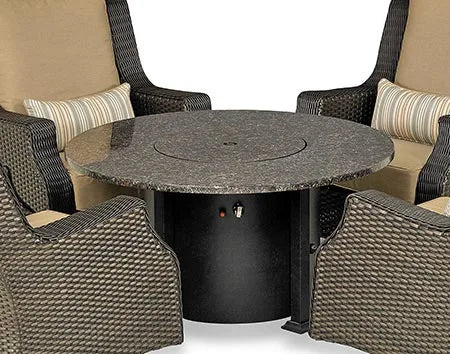  A round fire pit table with a granite top and a black metal base. The fire pit has a circular burner and a control panel with a knob and a switch. There are four swivel chairs with light brown wicker frames and beige cushions surrounding the table.