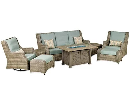  A 8-piece outdoor seating set with a rectangular fire pit table. The set includes a sofa, two swivel armchairs, two ottomans, and two side tables. The fire pit table has a square shape and a glass top. The cushions are light blue and the frame is brown.