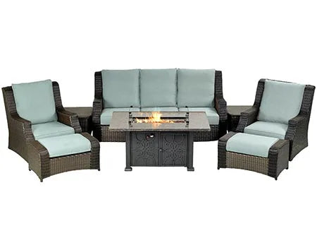 A 8-piece outdoor seating set with a rectangular fire pit table. The set includes a sofa, two armchairs, and two ottomans. The fire pit table has a square shape and a glass top. The cushions are light blue and the frame is brown.