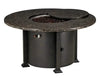 A round outdoor fire table with a granite top and a black metal base. The table has a circular burner and a control panel with a knob and a switch. A granite lid covers the burner, and a door on the side of the base reveals a storage compartment.