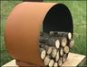 Close-up of a circular steel firewood rack with firewood stacked inside. The rack is resting on a wooden platform and has a rusted finish.